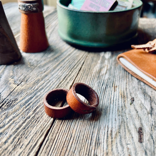 1974 Leather Ring Bands in Hickory sitting on a wooden bench, Handmade in the USA