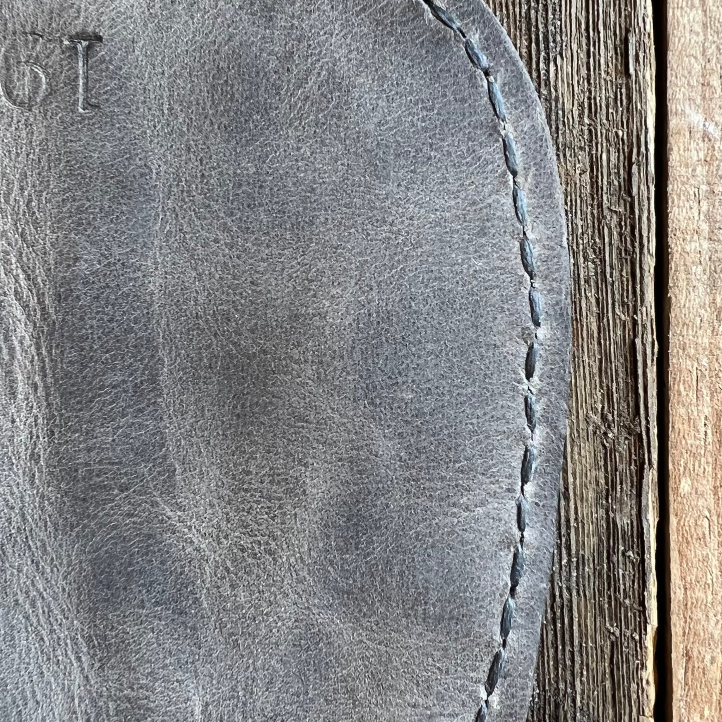 Charcoal stitching on smoke leather
